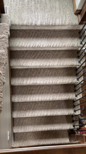 Freshly vacuumed carpeted stairs showing clean lines, a service provided by Yeilys Cleaning Services LLC in Omaha, NE.