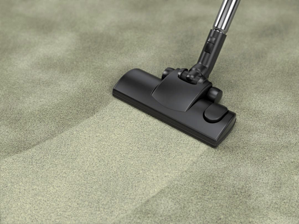 Thorough vacuuming of a green carpet by RJ Cleaning Services in Richmond, KY