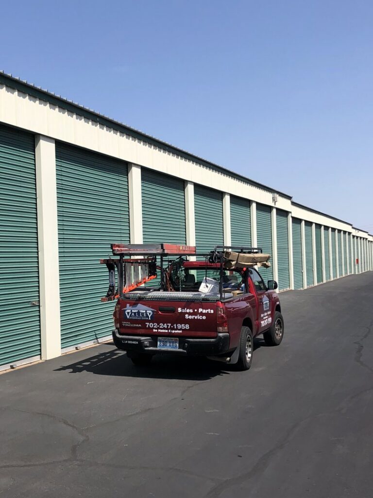 Valley Overhead Door's service truck parked at a storage facility with roll-up doors in Las Vegas, NV.