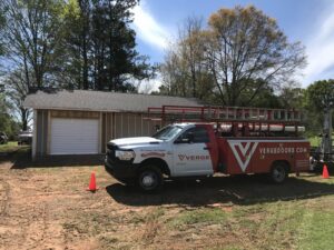 A Verge Entrance Solutions truck at a garage door installation on a construction site by Jonathan at Verge in Hattiesburg, MS.