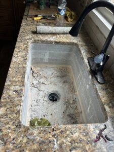 A very dirty kitchen sink with peeling grime before cleaning by Perfections Quality Cleaning Service in Dayton, OH.