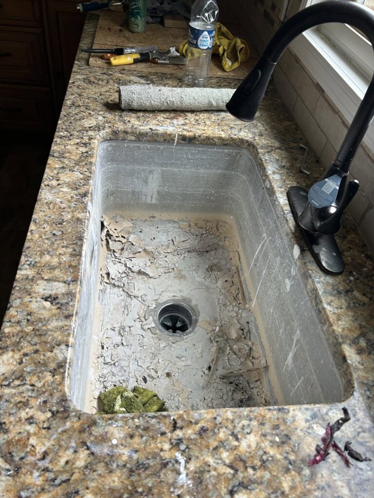 A very dirty kitchen sink with peeling grime before cleaning by Perfections Quality Cleaning Service in Dayton, OH.