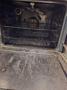 A very dirty oven interior before deep cleaning by Wonderful Laura Cleaning in Aurora, IL.