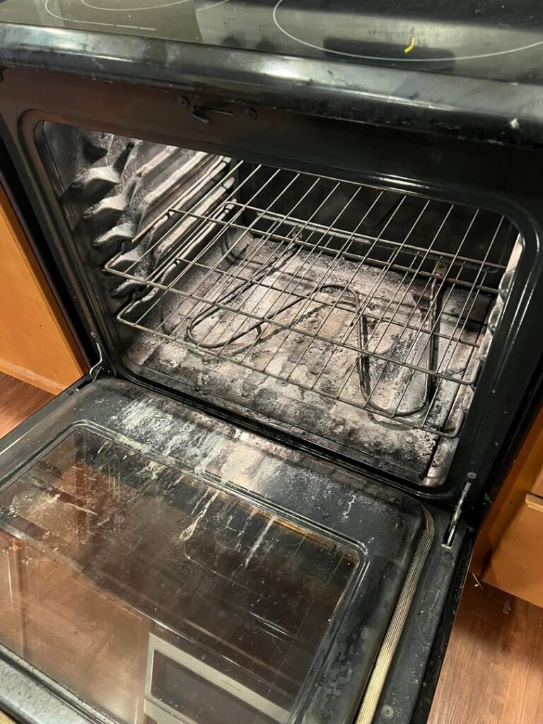 A very dirty oven interior with grime and burnt residue, before cleaning by Gem City Commercial and Residential Cleaning in Dayton, OH