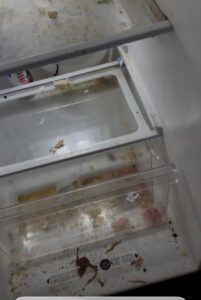 A very dirty refrigerator interior with drawers, illustrating a before-cleaning state for Bee-Dazzled Cleaning Service in Long Beach, CA.