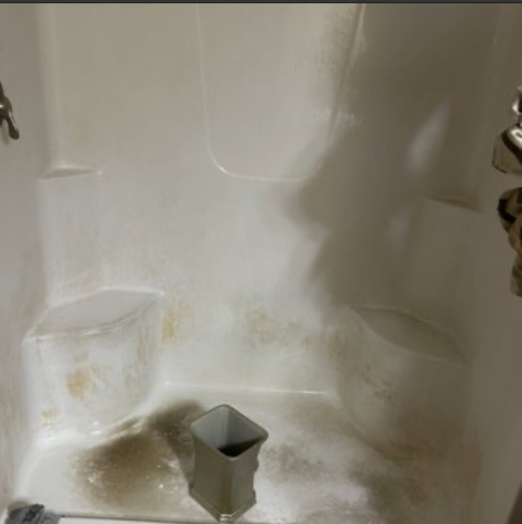 A very dirty shower stall with visible grime and mold, illustrating a 'before' scenario for Wilkie Wonders Cleaning in Akron, OH.