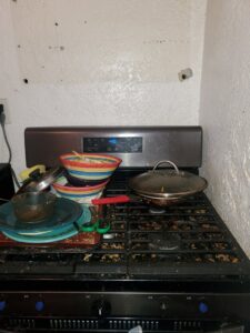 A very dirty stovetop with cooking residue, showing the need for deep cleaning by Chelle's Cleaning Services in Gary, IN.