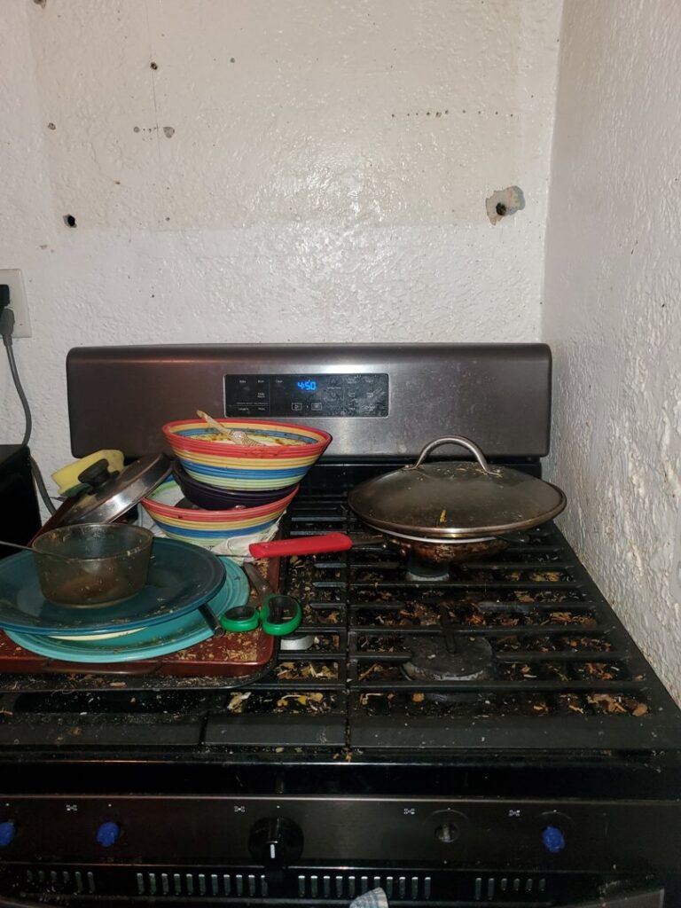 A very dirty stovetop with cooking residue, showing the need for deep cleaning by Chelle's Cleaning Services in Gary, IN.