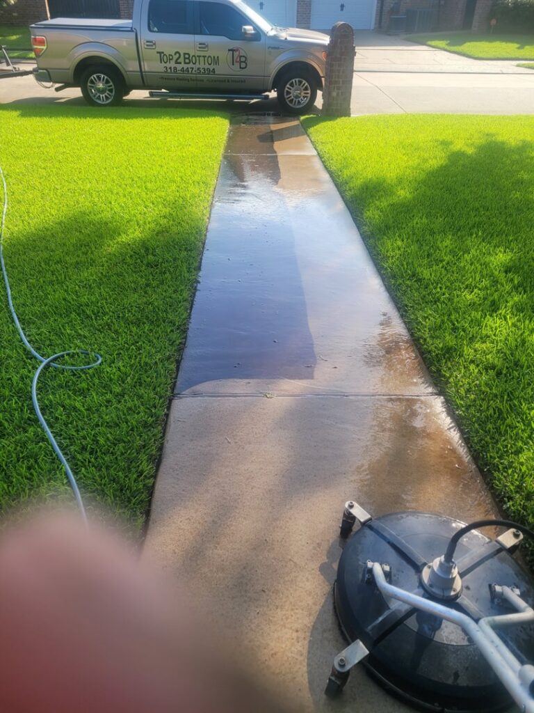 A professional pressure washing a residential walkway for Top2Bottom Pressure Washing & Exterior Cleaning in Alexandria, LA.