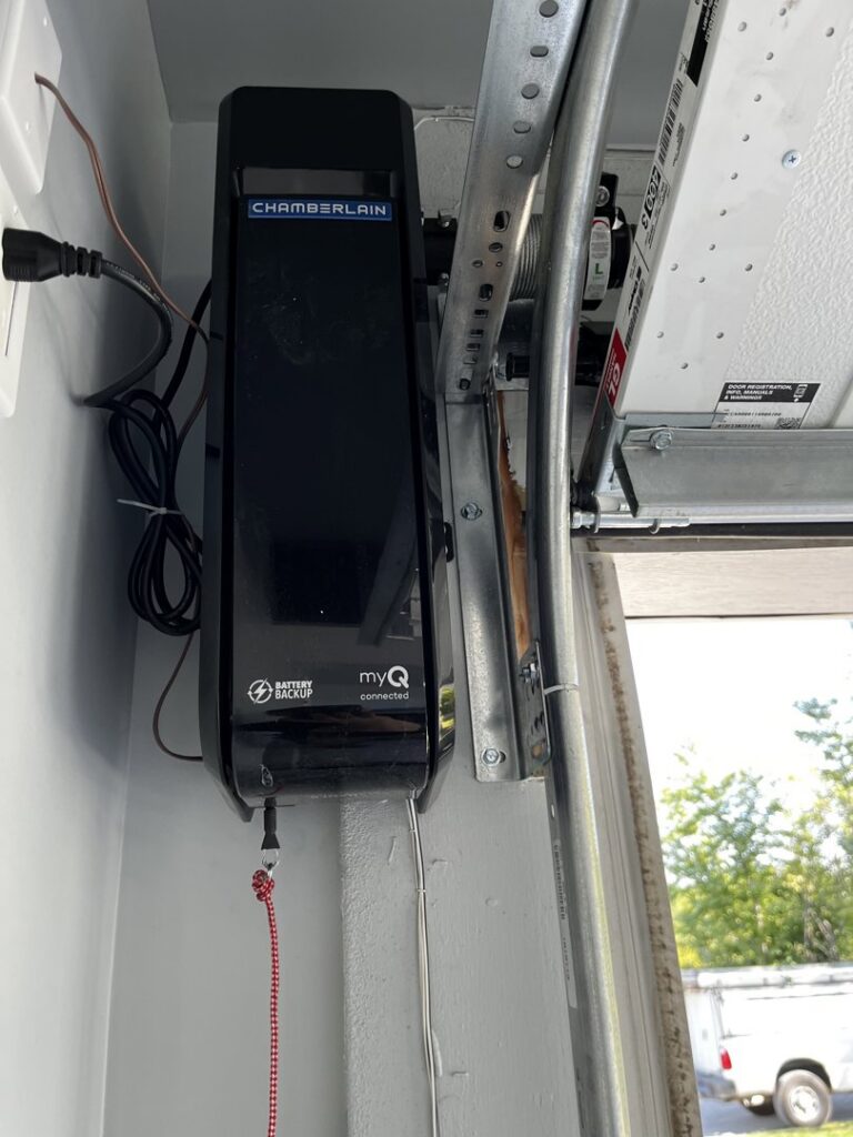 A wall-mounted Chamberlain garage door opener and track system, installed by Over The Top Garage in Albuquerque, NM.