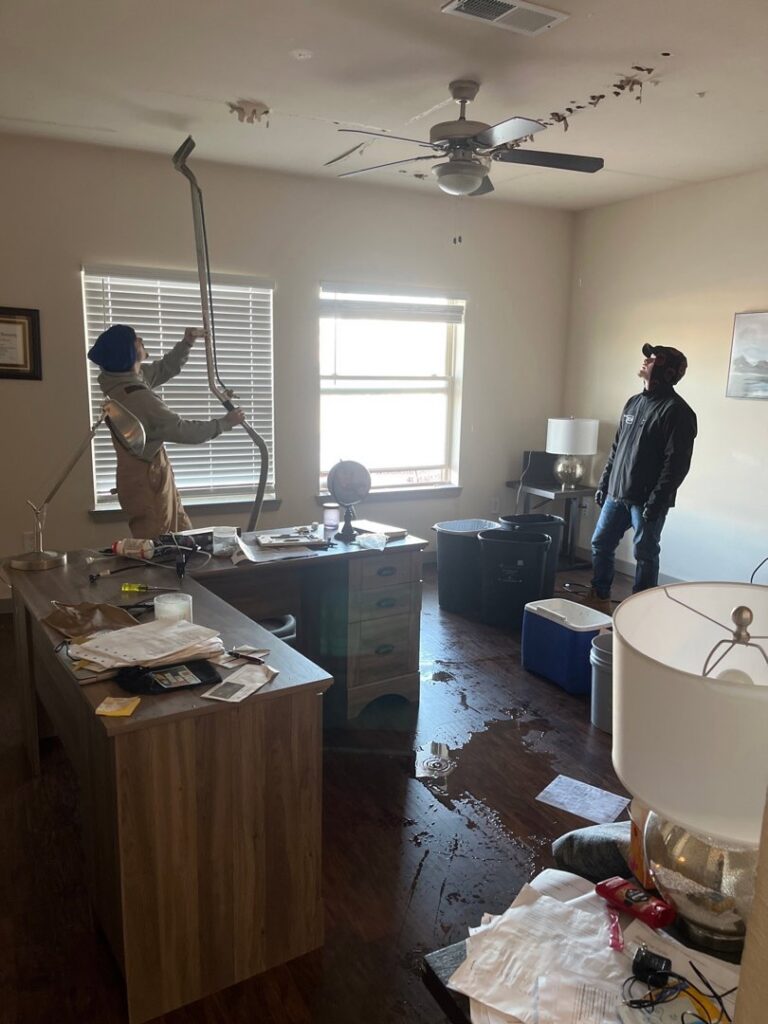 OKSR - Property Restoration Services technicians repairing a water-damaged ceiling in an office in Oklahoma City, OK.