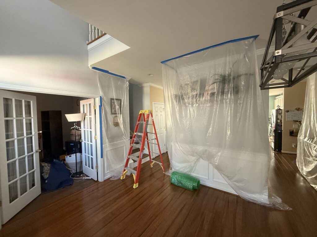 Interior of a home with plastic containment barriers set up for water damage remediation by Carolina Pro Restoration LLC in Fort Mill, SC.
