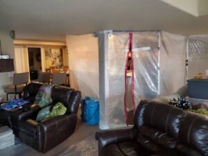 Water Damage, Inc. containment and drying equipment in a living room restoration in Denver, CO.