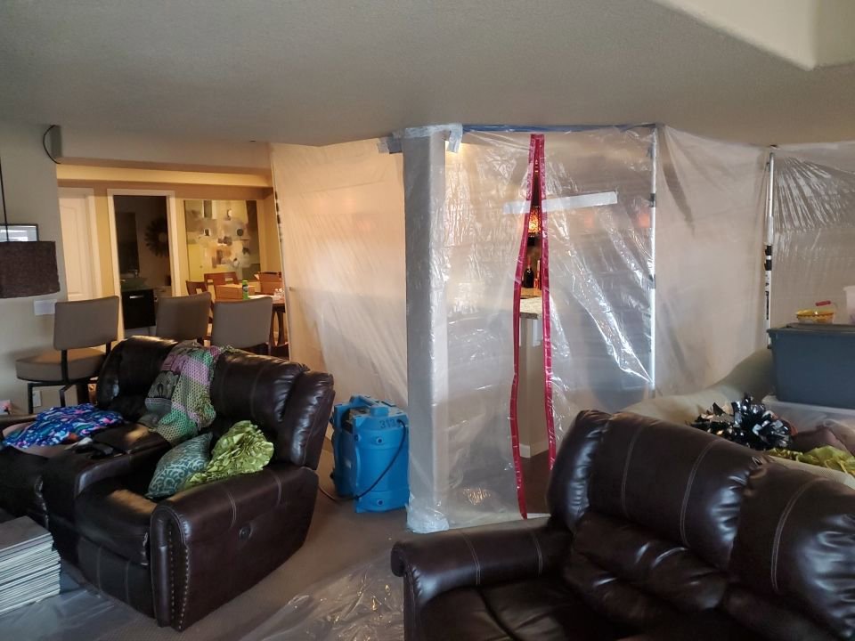 Water Damage, Inc. containment and drying equipment in a living room restoration in Denver, CO.