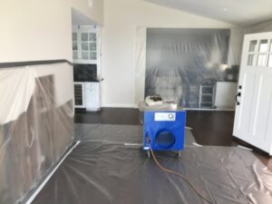 Water damage containment and drying setup with plastic sheeting and an air mover by Best Dry Flood and Mold Specialists, Inc. San Diego, CA