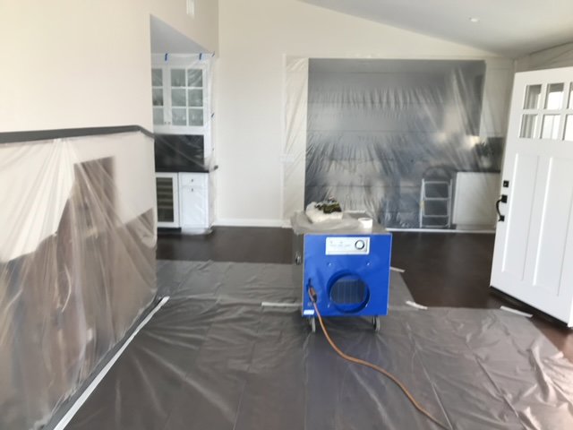 Water damage containment and drying setup with plastic sheeting and an air mover by Best Dry Flood and Mold Specialists, Inc. San Diego, CA