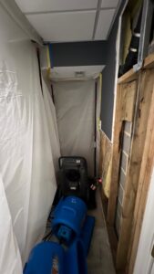 Water damage containment and drying equipment in a confined space, used by Doctor Fix-It in Denver, CO.