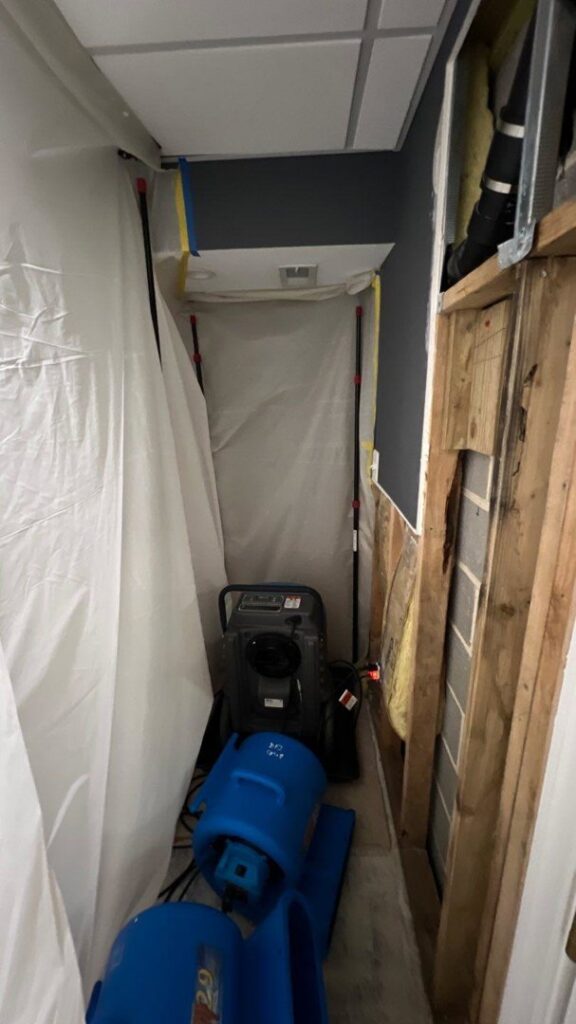 Water damage containment and drying equipment in a confined space, used by Doctor Fix-It in Denver, CO.