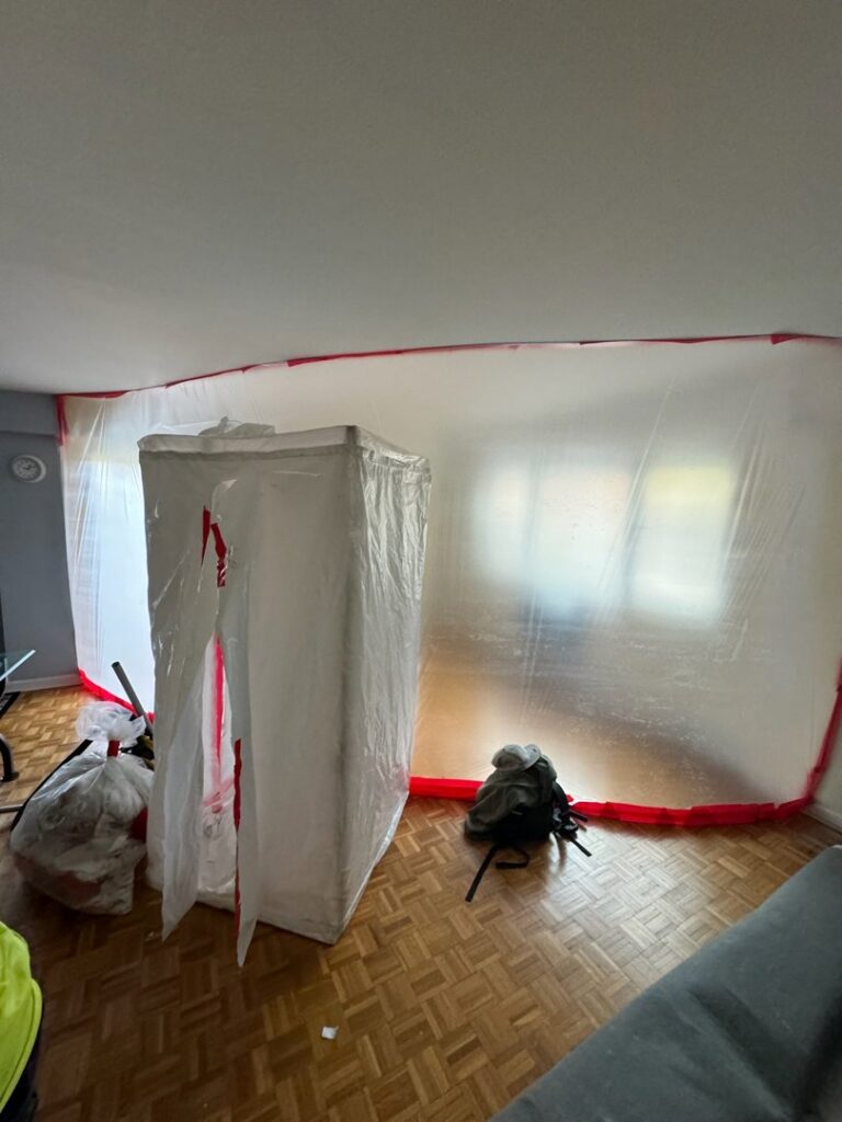 A room with plastic containment barriers set up for water damage remediation by RestoPros of Hartford in West Hartford, CT.