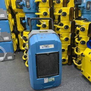 A blue industrial dehumidifier and air movers used for water damage restoration by TriStorm in South Bend, IN