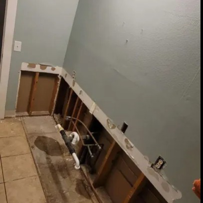 Water damage demolition in a bathroom showing removed cabinetry and exposed plumbing by 13:12 Cleaning & Restoration, LLC in Bessemer, AL