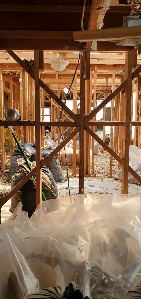Interior demolition with exposed studs and debris bags during water damage restoration by Bordi Restoration in San Leandro, CA