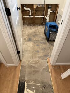 Demolished wall with exposed pipes and drying equipment during water damage restoration by RestoPros of New Haven in Prospect, CT