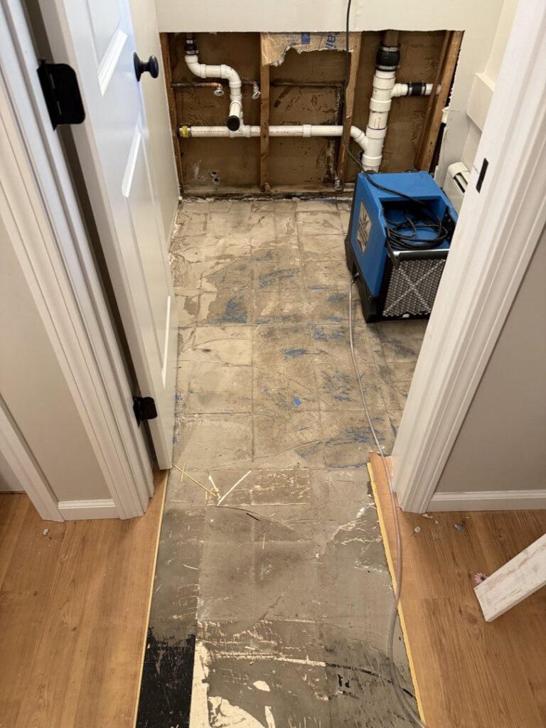 Demolished wall with exposed pipes and drying equipment during water damage restoration by RestoPros of New Haven in Prospect, CT