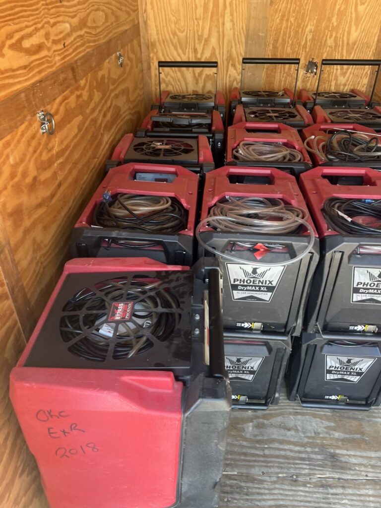 Phoenix DryMax XL dehumidifiers, essential equipment for water damage drying, stacked in a trailer for Paul Davis of Norman & SW OKC in Norman, OK.