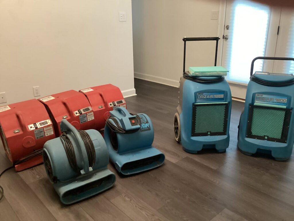 Multiple air movers and dehumidifiers used as drying equipment for water damage restoration by Carolina Pro Restoration LLC in Fort Mill, SC.