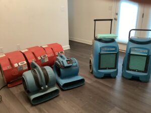 Multiple air movers and dehumidifiers used as drying equipment for water damage restoration by Carolina Pro Restoration LLC in Fort Mill, SC.