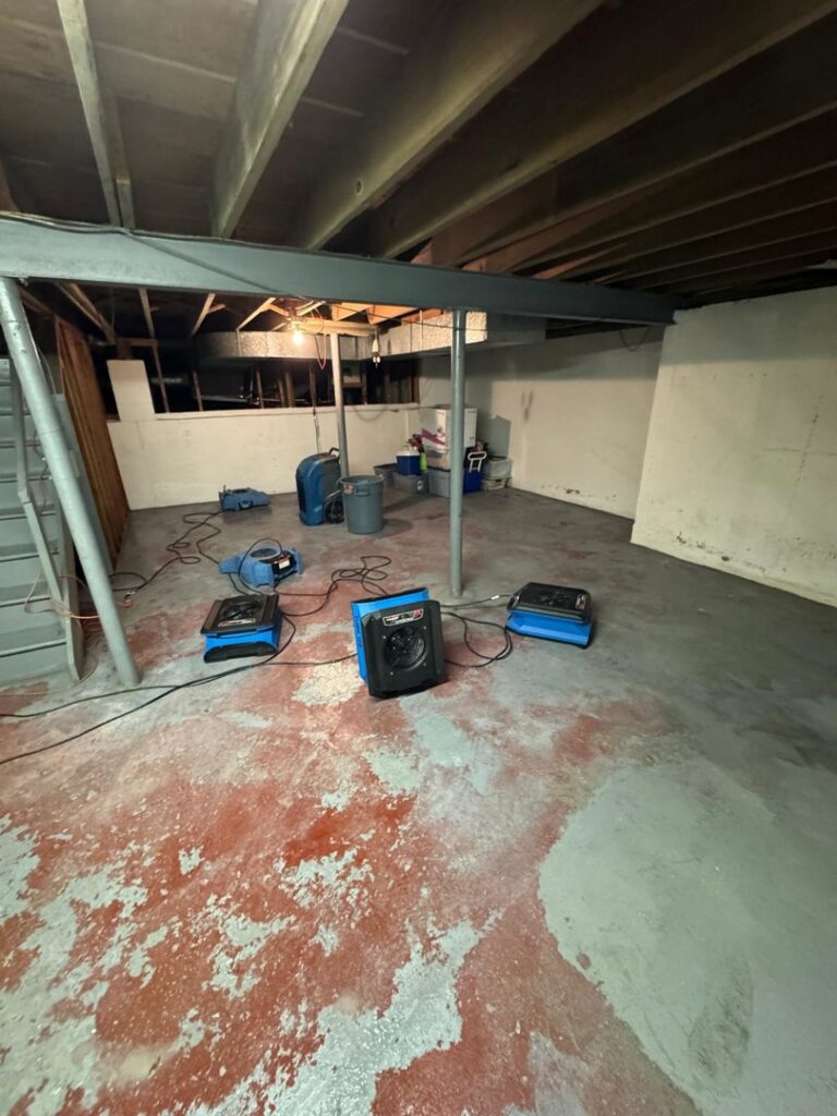 Professional drying equipment set up in a basement for water damage restoration by Island Emergency Disaster Restoration in Farmingdale, NY.