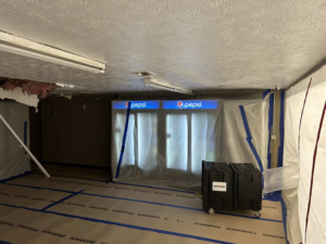Drying equipment and plastic containment in a room during water damage restoration by Paul Davis of Eastern Ohio in Youngstown, OH.