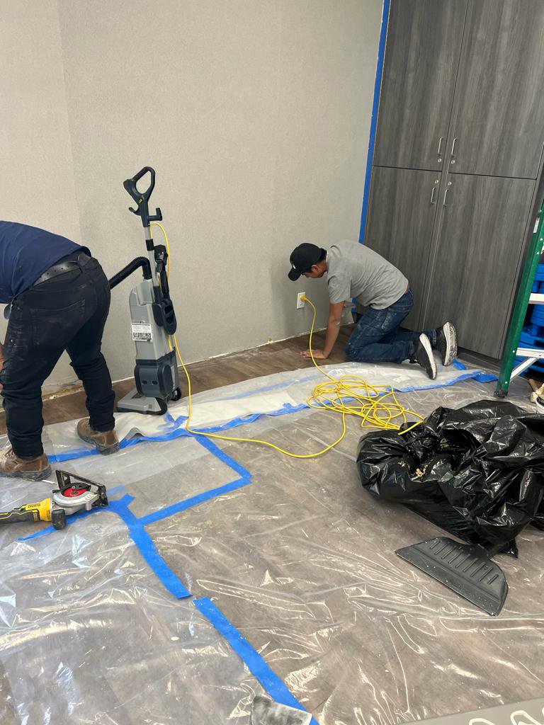 Water damage specialists from Rainbow Restoration of Meridian setting up drying equipment and containment barriers in a damaged room in Meridian, ID.