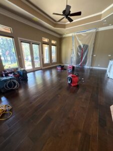 Water damage drying equipment and plastic containment set up in a room by Restoration Xperts Emergency 24/7 in Deerfield Beach, FL.