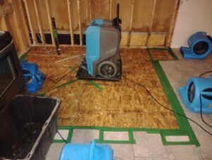 Water damage drying equipment, air movers, and a dehumidifier, in a room during restoration by Robinson Restoration, Vancouver, WA