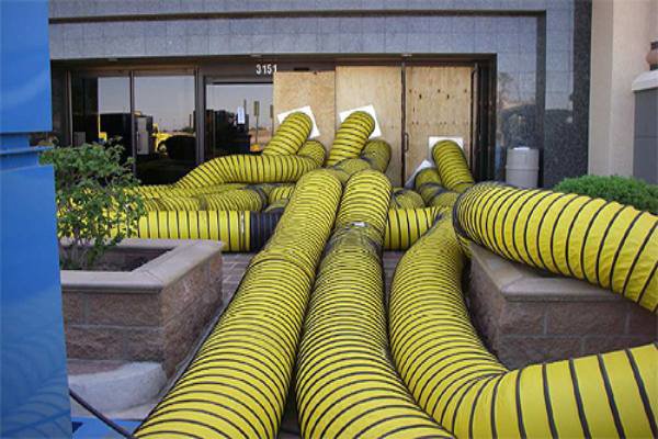 Large yellow drying ducts used for water damage restoration by Emergency Response Services Inc. in Warren, MI