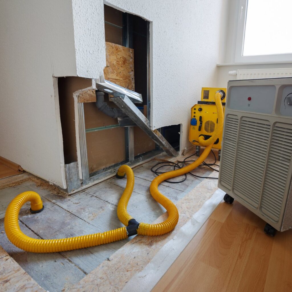 Drying equipment and exposed wall studs during water damage restoration by Built Different Restoration in Gilbert, AZ.