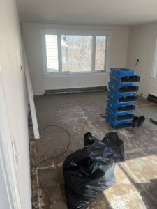 Drying equipment and air movers set up in a water-damaged room by Paul Davis Restoration of Greater Portland, ME in Falmouth, ME.