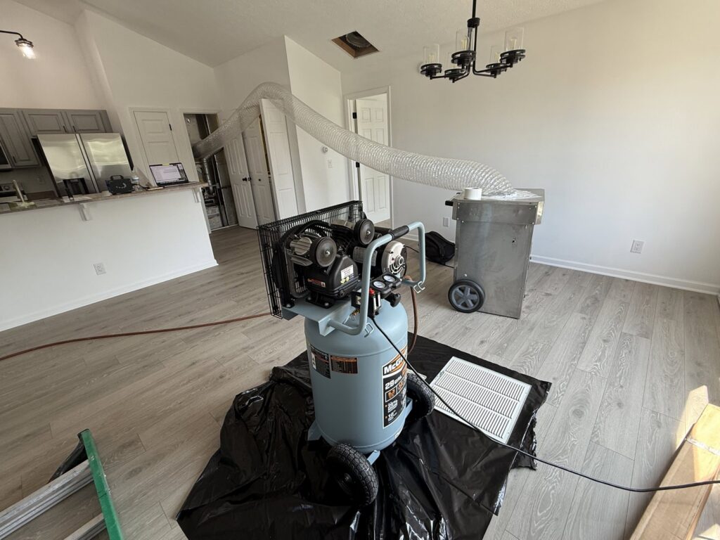 Water damage drying equipment, including an air compressor and dehumidifier, set up in a home by Magna-Dry in Lafayette, IN