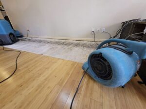 Professional drying equipment and air movers working on a water-damaged floor during restoration by RestoPros of Lancaster, PA.