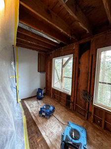 Industrial drying equipment and exposed studs during water damage restoration by PacWest Restoration in Tigard, OR