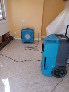 Industrial drying equipment and exposed wall studs during water damage remediation by Bordi Restoration in San Leandro, CA