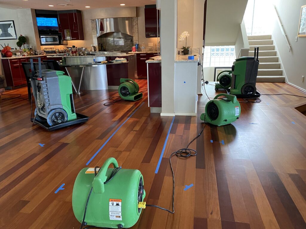 Water damage drying equipment, including air movers and dehumidifiers, set up in a home by Servpro of East Honolulu, HI.
