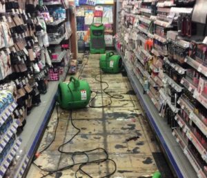 Water damage drying equipment, including air movers, set up in a store aisle by SERVPRO of Newark in Wilmington, DE