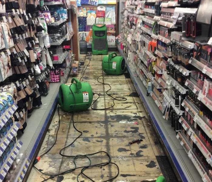 Water damage drying equipment, including air movers, set up in a store aisle by SERVPRO of Newark in Wilmington, DE