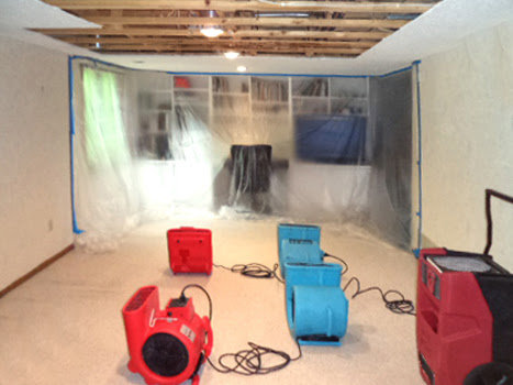 Industrial fans and dehumidifiers drying a room after water damage remediation by Ungerman, Inc. in Plymouth, MN