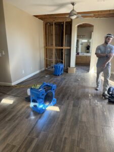 Water damage drying equipment and exposed framing during restoration by Western Skies Restoration in Gilbert, AZ.