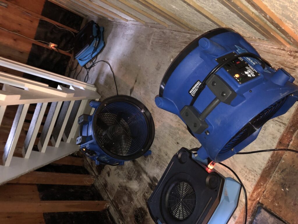 Multiple industrial fans and dehumidifiers set up for water damage drying on a subfloor by Rainbow International of Coeur D'alene in Post Falls, ID