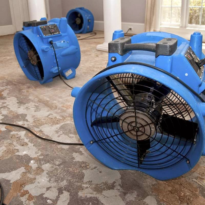 Three blue industrial drying fans on a damaged floor for water damage restoration by Rainbow Restoration of the Capital Region in Clifton Park, NY